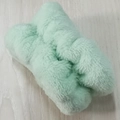 Light green plush bow headband and matching wristband set on a wooden surface - Green Wristbands 1 Pair