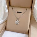 Détail d'un pendentif flocon de neige argenté avec zircons dans son écrin à bijoux - Style Flocon de Neige Argenté Avec Zircone (M112)
