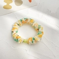 Yellow-green scrunchie with botanical patterns and a transparent plastic link detail - Yellow Cherry Small