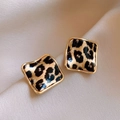 Detailed macro view of square leopard print earrings with gold plating on silk fabric - Gold Leopard Square (Silver Earring Post)