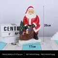 Figurine de Père Noël de 28cm en résine tenant un sac cadeau et un petit sapin - Père Noël avec des Cadeaux