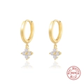 Macro detail of S925 sterling silver four-leaf clover earrings with sparkling zircon stones - Gold with White Zirconia