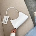 White croc-effect underarm bag in a crescent shape with elegant gold zipper details - White