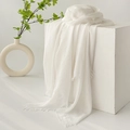 Breathable white linen scarf with fringed edges draped over a minimalist cube - White