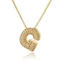 Macro detail of gold-plated letter G pendant with micro-paved cubic zirconia stones - Letter G