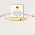 Detailed shot of pink woven bracelet with 'Just breathe' engraved golden tube on a card - Just Breathe Gold Bar Pink Rope With Card