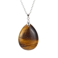 Macro shot of polished teardrop tiger eye stone pendant with silver metal chain necklace - Tiger Eye