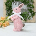 Detail of pink resin bunny with woven texture and a white ribbon bow for garden decor - Pink Standing