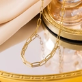 Minimalist 18K gold plated paperclip link necklace on a reflective warm gold surface - Necklace - Gold