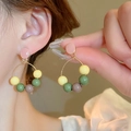 Colorful beaded drop earrings with gold hoops and candy-colored beads on a female model - Silver Earring Post-Pink-Green (Colorful Beads)