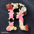 Golden letter R brooch with pearls and red rhinestone strawberry detail, 3.6x4.3cm - Letter R