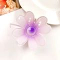 Macro detail of translucent purple frangipani hair claw clip with gradient resin petals - Clover Lavender Purple