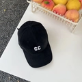 Close-up of white CC letter embroidery on a premium black cotton baseball cap - Black