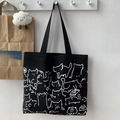 Detail of black canvas tote bag with cute white hand-drawn cat illustrations and long straps - Black Cat