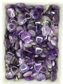 Macro shot of polished heart-shaped amethyst stones with natural purple patterns - Dreamy Amethyst