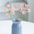 Handmade crochet flower bouquet with pink petals and green stems in a blue vase - 5-Head Forget-Me-Not Pink