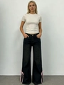 Detail of pink ribbon bow laces on the side of black wide-leg denim jeans - S / Vintage Blue