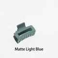 Close-up of a matte light blue hollow rectangular mini hair claw clip for women - Matte Light Blue