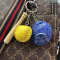 Detail of mini baseball keychain with wood bat and blue glove on a patterned bag strap - 3.5CM Yellow Ball Royal Blue
