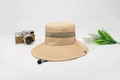Beige outdoor sun hat with breathable mesh and Outdoors embroidery in a flat lay view - Khaki