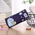 Close-up of a dark blue cartoon dinosaur pencil case with Luck text on a wooden desk - Cute Little Dragon