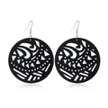 Detail of black hollowed-out wooden earrings with tribal geometric patterns and metal hooks - Style 16 (Tribal Ring)