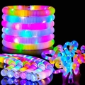 Detail showing glowing LED pop tubes being stretched and twisted in the dark - 2.9*18.5 LED Pop Tube