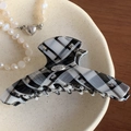 Classic black and white checkered hair claw clip with a refined gold oval metal logo tag - 10.5cm