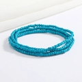 Macro shot of 2mm handmade cyan glass beaded elastic waist chain with vibrant colors - Cyan Blue