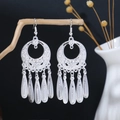 Detailed close-up of Bohemian silver drop earrings with circular hollow patterns and tassels - Silver Hollow Drop Pendant(E4153)