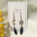 Detail of sun and moon asymmetrical earrings with blue raw stone and wire wrap style - Blue Sodalite