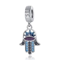 Macro shot of silver Hamsa charm with blue star, purple eye and embedded crystals - Hollow Blue Star Hamsa