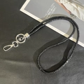 Detail of black glitter crossbody phone strap with silver lobster clasp on a textured surface - 6mm Rhinestone Pendant / Black (K3141)