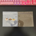 Detail of transparent and brown plastic zip bags with cute cartoon dog print pattern - Good Luck
