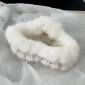 Close-up of white plush hair claw clip with soft faux fur and acrylic frame on textured paper - Cloud Style / White