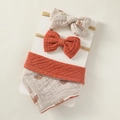 Detailed view of baby bib and bow headband set in soft waffle cotton with rainbow print - 7-Brick Red Rainbow