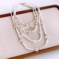 Detail of multi-layer pearl and crystal necklace on a wooden tray with golden clasp - White (14# Necklace)