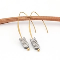 Minimalist gold ear hooks with grey arrow pendants displayed on a natural wooden branch - Silver
