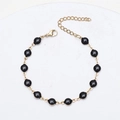Detail of 18K gold plated stainless steel chain bracelet with black enamel beads - Gold + Black