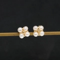 Elegant white freshwater pearl stud earrings with gold clover setting on a black background - White Pearl Flower Style