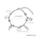 Bracciale oceano in acciaio al titanio con diamanti cechi, ciondoli stella marina e delfino, oro 18k - Tema Oceano / Argento
