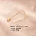 Detail of gold stainless steel extension chain with lobster clasp on pink silk - 18K Gold Plated 3 Segments