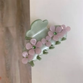Detail of light green acetate hair claw clip featuring pink flowers and green rhinestones - Green Pink Flower