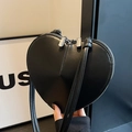 Minimalist black heart-shaped crossbody bag in smooth leather with a slim shoulder strap - Black