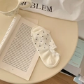 Beige no-show socks with black polka dot pattern for women in a cozy lifestyle setting - One Size / Off White
