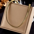 Gold plated punk style chain necklace in a unique zipper tooth design on a jewelry box - Gold