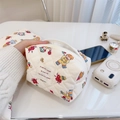 Handheld view of quilted cotton makeup bag with colorful cartoon prints and zipper - Trapezoid Storage Bag