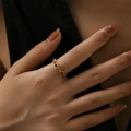 Detail of slim gold ring with red round gemstones worn on index finger for daily wear - Adjustable Open / Red (KR0040-2)