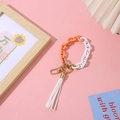 Fashionable acrylic chain wristlet keychain with white tassel and gold lobster clasp - Orange + White