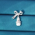 Silver Christmas snowman charm with bowknot and crystal accents on blue fabric - Snowman Style